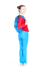 Studio portrait of schoolgirl posing with backpack on white background