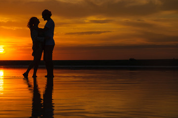 silhouettes of a loving couple at sunset . the concept of love and romance. Card for Valentine's day.