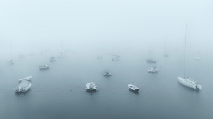 boats in port at foggy morning