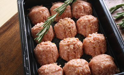 meatball forcemeat beef pork on wooden background rosemary