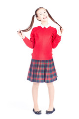 Asian female elementary student in school uniform posing on white background