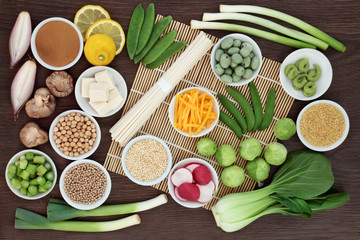 Macrobiotic diet food with japanese udon noodles, tofu, miso and wasabi paste, grains, legumes, vegetables and wasbai nuts with foods high in protein, antioxidants, fibre, vitamins and minerals.  