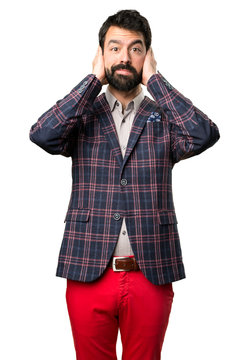 Well dressed man covering his ears on white background