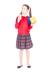 Portrait of Asian schoolgirl in uniform holding lunchbox and paper cup with drinking straw
