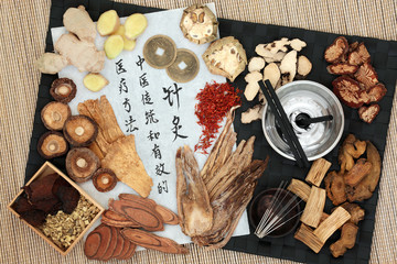 Chinese moxa sticks and acupuncture needles with herbs, Feng shui coins and calligraphy script....