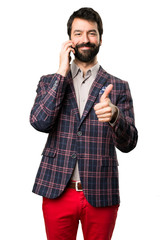 Happy Well dressed man talking to mobile on white background