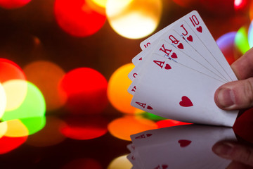 Royal flush poker cards combination on blurred background casino luck fortune card game