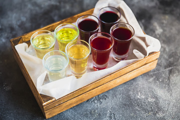 Assorted alcoholic cordials in a wooden box. Alcoholic drinks