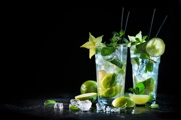 Fotobehang Twee glazen mojitococktail met verse limoen en munt © Alexander Raths