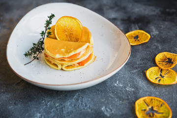 Pancakes with salmon fish on a white plate. Tasty food.