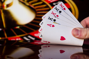 Four of a kind poker cards combination on blurred background casino luck fortune card game