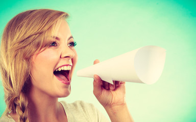 Woman screaming through megaphone made of paper