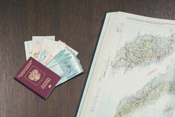 Female planning trip around south-east Asia. Russian passport, map and asian money on the table