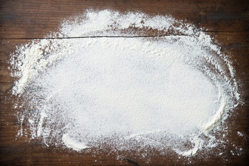 Baking background with flour on wooden table