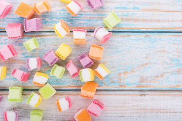 closeup colorful candy and jelly sweet on wooden