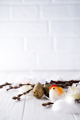 Obraz premium Easter quail eggs with hare ears and willow branch