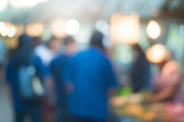 abstract blur image of food stall at night festival with bokeh for background usage