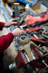 Fototapeta na wymiar Close up shot of worker hands fixing car ball bearing and conveyor belt
