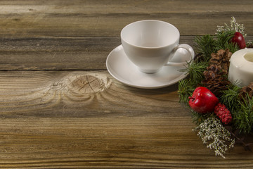 Coffee Cup on wooden table with a wreath oriented to the Right