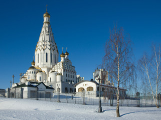 The white-stone Cathedral of all the saints with golden domes on the background of the blue sky.Minsk.Belarus.