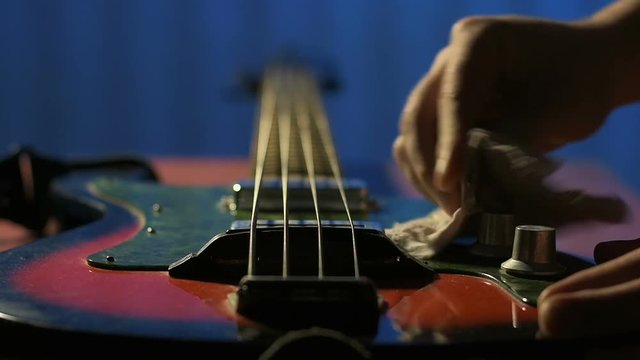 Guitarist rubs toggle switch on his old bass guitar