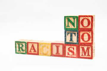 composing letters into words, "no to racism".