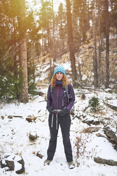 a young woman backpacking in the snow in the Rocky Mountains.