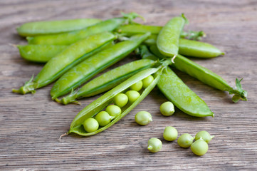 ripe Green peas over wooden background