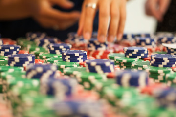 Multicolored poker chips exhibited by a pile