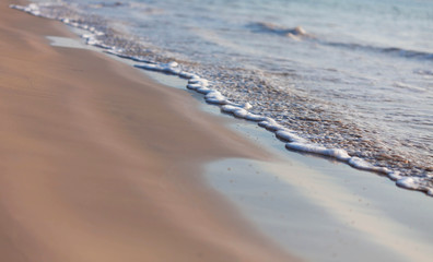 clean sea sand and the wave are blowing  on the beach 