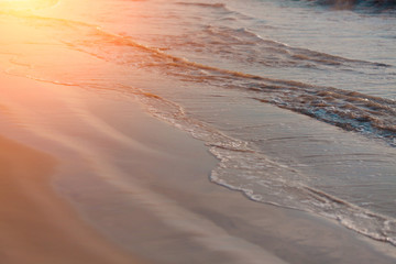 sunlight with clean sea sand and the wave are blowing  on the beach/Thailand