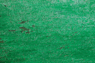Texture of a wooden board in green. The chapped green paint on the surface of the turf