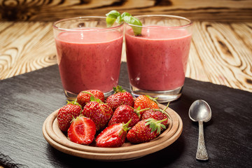 healthy strawberry yogurt with fresh berries on old wooden background