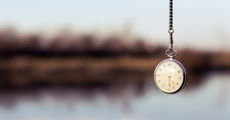 Pocket watch hanging from sky