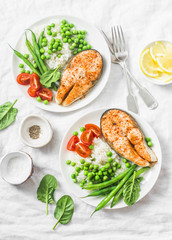 Healthy balanced mediterranean diet lunch - baked salmon, rice, green peas and green beans on a light background, top view. Flat lay