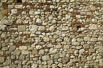 Full frame texture background of an old rubble stone and brick wall construction