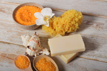fruit bath salt with olive oil and gray natural soap next to the orchidwith place for text
