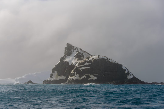 Rock with snow in sea