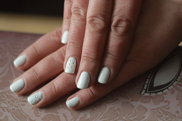 Female hands with white manicure