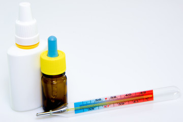 Different pills, medications with medicine with thermometer on white background