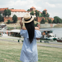 Fototapeta premium Young brunette woman walking and relaxing in old city street