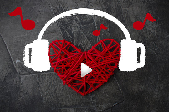 Heart in headphones on a dark background. Theme for Valentine's Day. Wedding, love 2