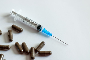 syringe and pills on the table