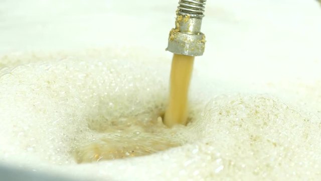 cooking barley grains for producing beer at the brewery.