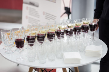 out catering, glasses with white and red wine, champagne, whiskey, juice or mineral water are on  table for the guests of  event