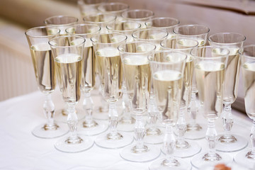 glasses with white  champagne on table for guests of the event, out catering