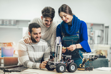 Young students of robotics preparing robot for testing in workshop © Mediteraneo