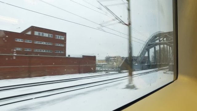 High angle View from the window of a high-speed train on the old village and frozen river