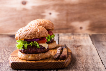 Hamburger with lettuce, cheese. tomato, red onion