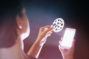 Image of a girl with a smartphone in her hands. She's holding a pizza icon. Search and online order pizza.